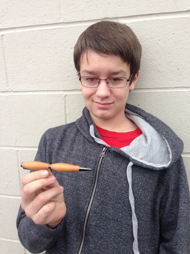 me holding the pen I made
